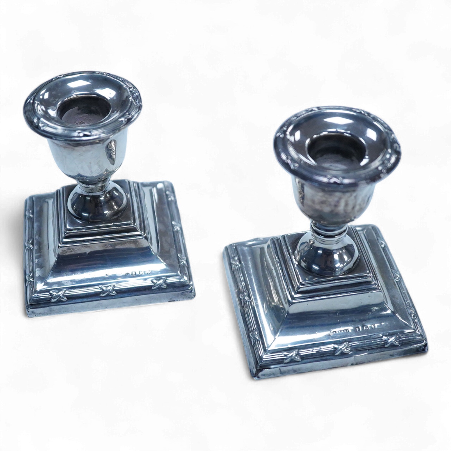A pair of George V silver mounted dwarf candlesticks, Birmingham, 1920, height 86mm (a.f.), together with a cased Victorian silver beaded Old English pattern christening knife and fork, George Adams, London, 1881.